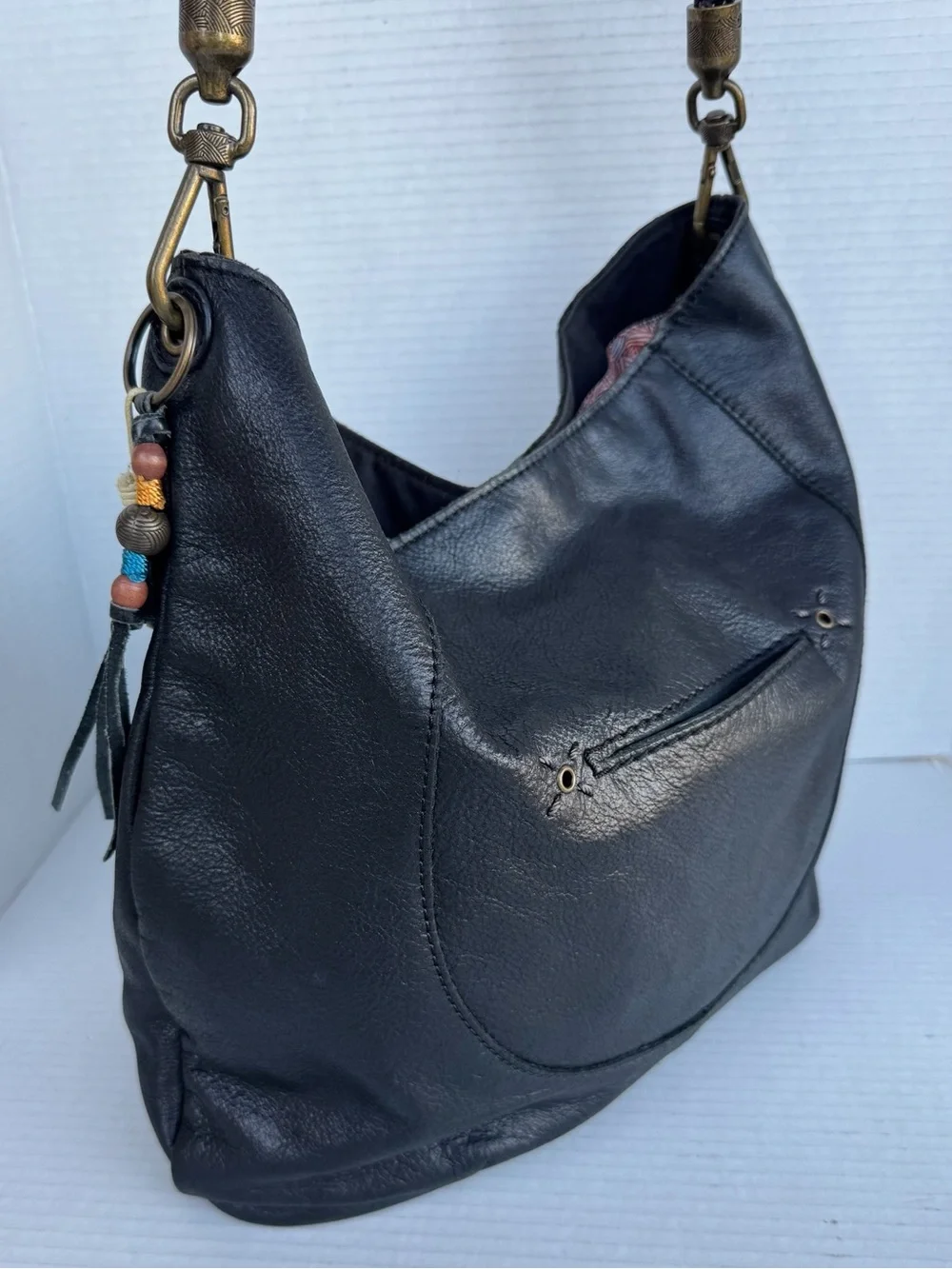 The Sak Black Leather Hobo Bag Braided Strap & Tassel Charm